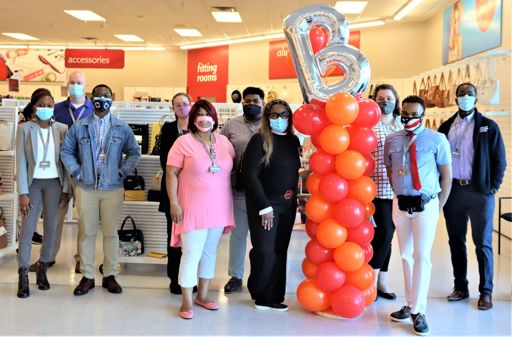 District mnger Tracie Bogan and Store mnger Charles dorsey pose with all the staff.JPG